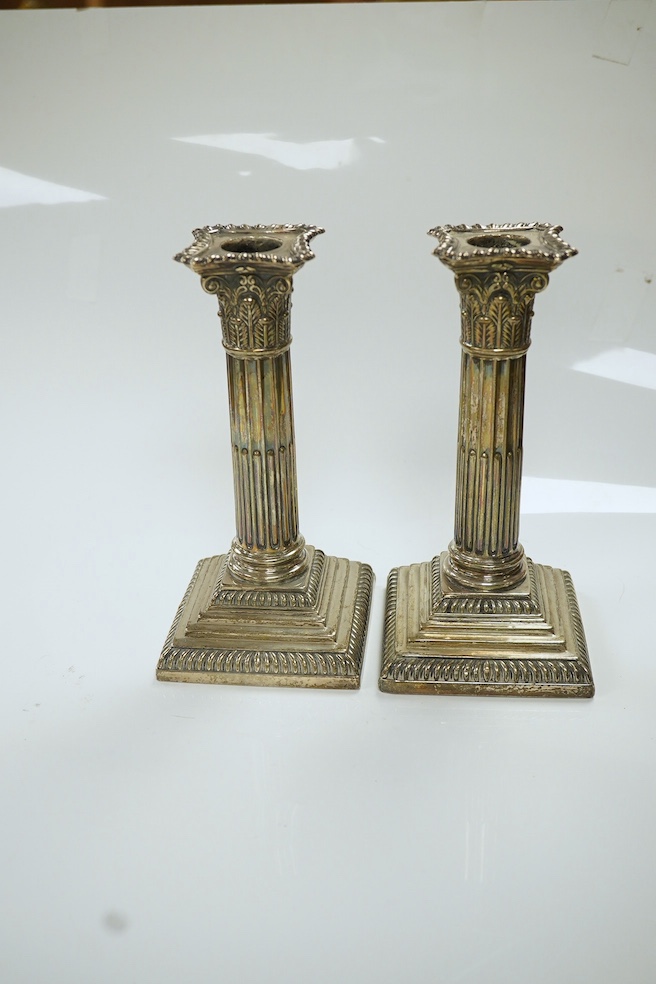 A pair of late Victorian silver Corinthian column dwarf candlesticks, Hawksworth, Eyre & Co, Sheffield, 1899, height 17.4cm, weighted. Condition - poor to fair